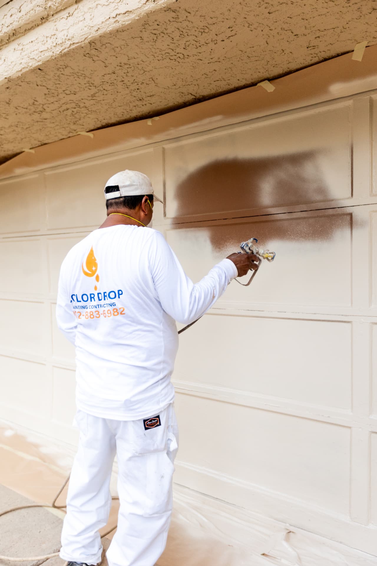 Color Drop Painting contractor spraying an exterior surface